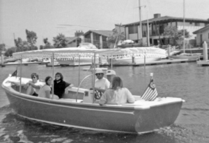 a group of young people in an electric boat in the 1970s