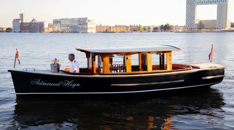 Electrified canal boats of Amsterdam include classic wood salon boats