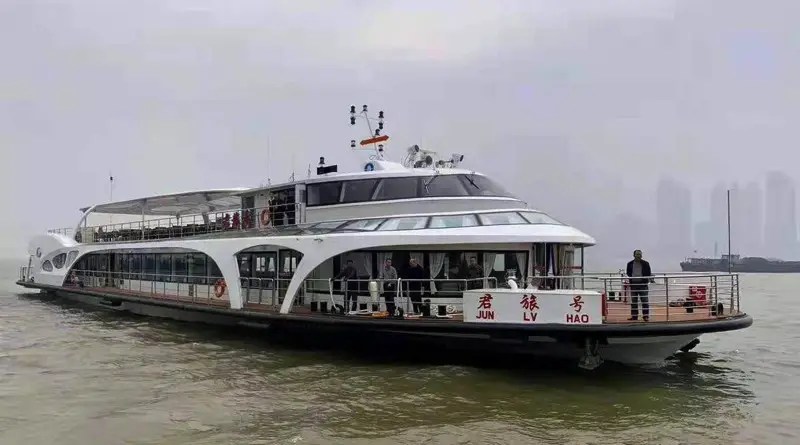 China's electric ferry takes passengers along the Yangtze river with heavy smog in the background