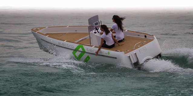 open deck electric boat speeding through the water