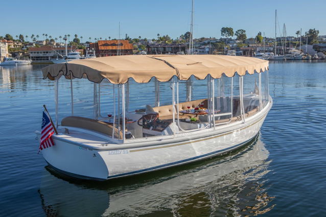 Classic Duffy Boat electric boat with fringe surrey top