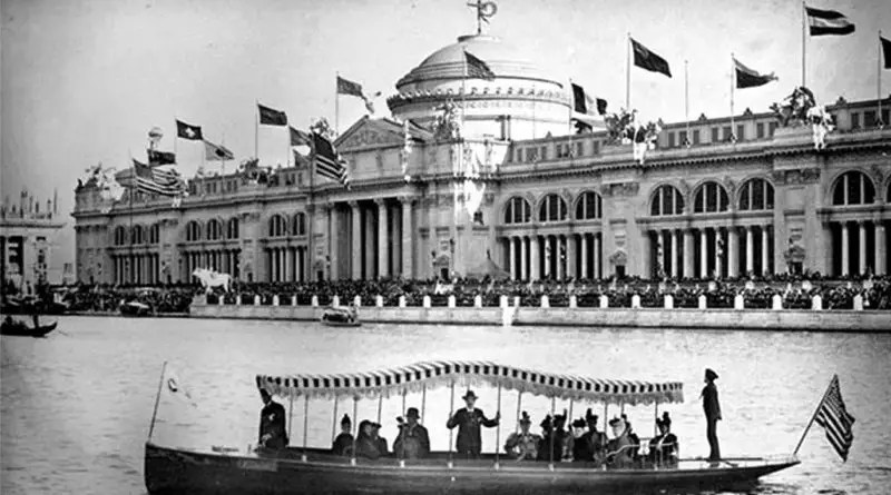 long electric boats with fringed roofs on the lake in front of a large building at the 1893 Chicago World's Fair