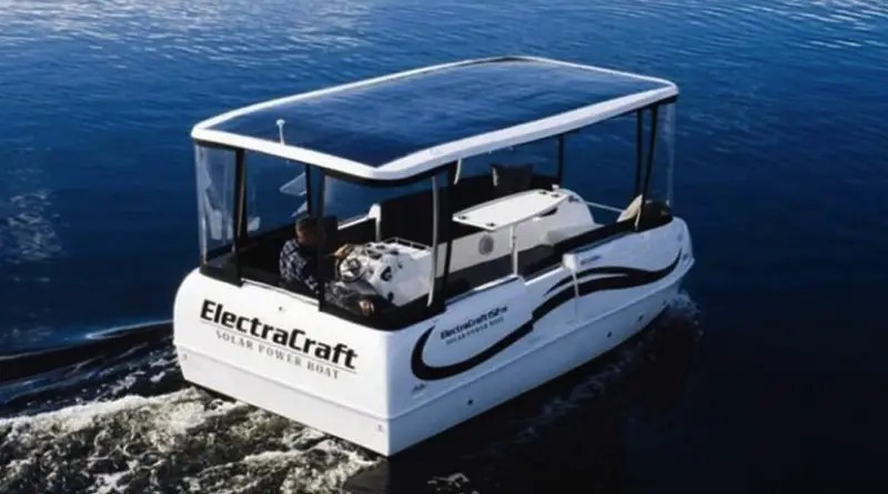 A pontoon style boat with a solar roof