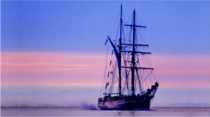 electric boat milestones - Zebu tall ship with sails down at sunset