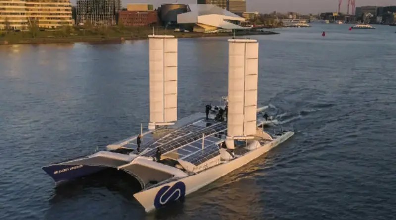 A large catamaran boat with two huge pillars on each deck that are sailwings