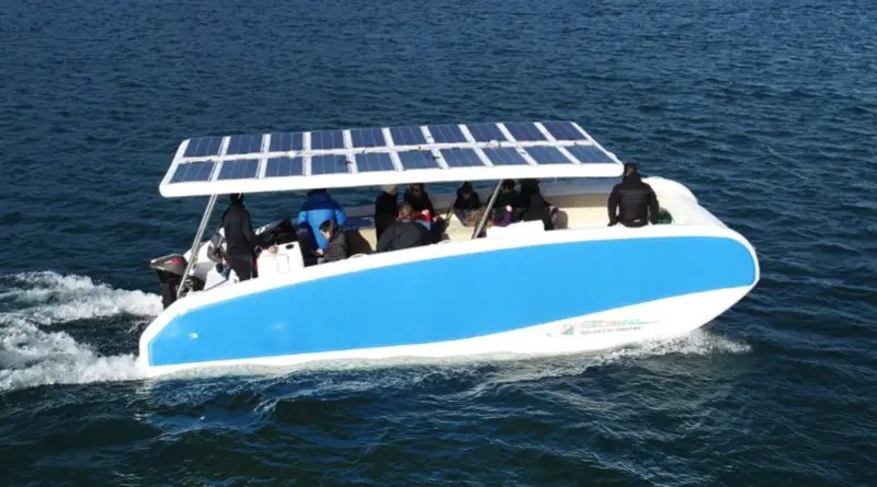 new inflatable solar boat cruising along in the water with passengers.