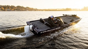 electric boat packages: The Tracker bass boat speeds along a lake