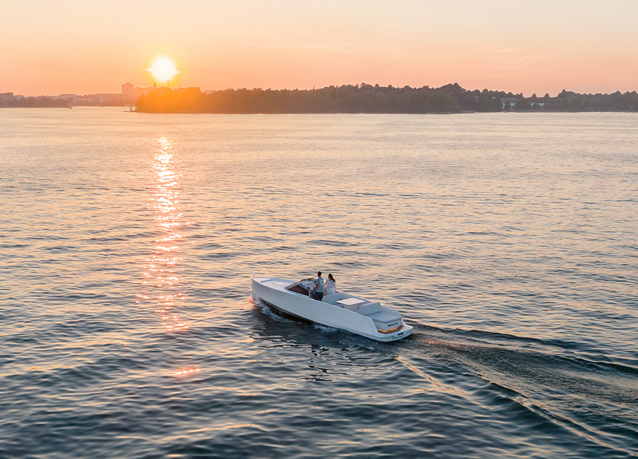 Electric boat on the water with a sunset