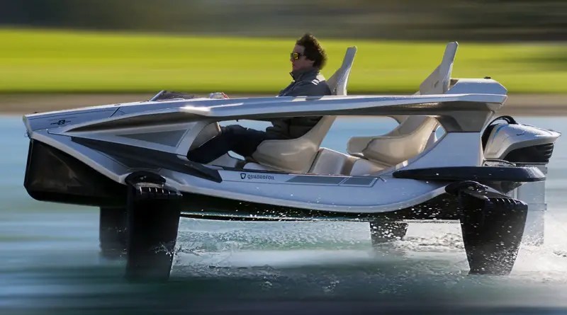 a man drives an open sided jetboat with hydrofoils that keep it flying above the water