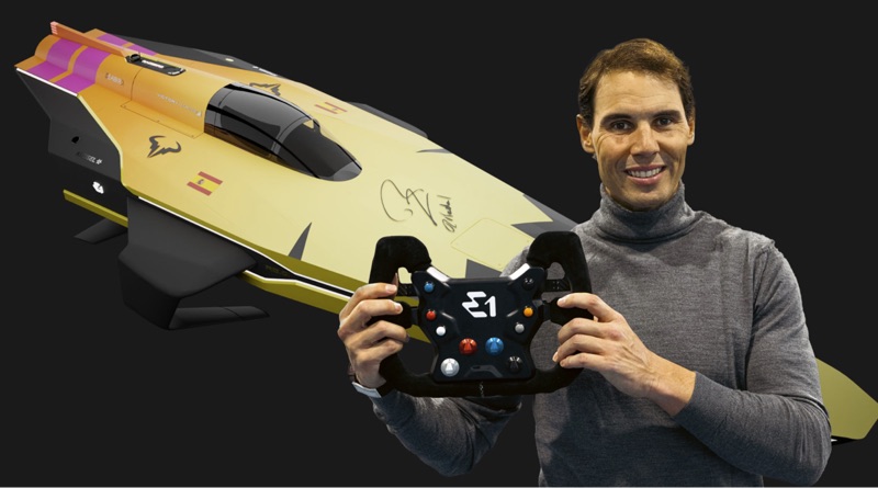 Rafael Nadal electric boat team leader holding boat steering wheel with E1 boat behind him