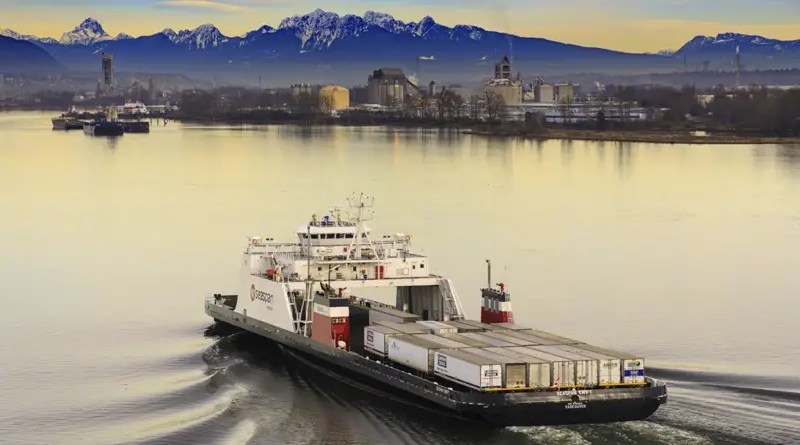 a battery powered large ship in a harbour with mountains in the background