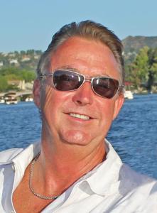 CLose up photo of Skip Toller beside a lake