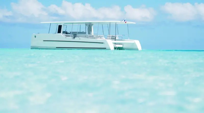 solar electric yacht floating in the aquamarine waters of the South Pacific