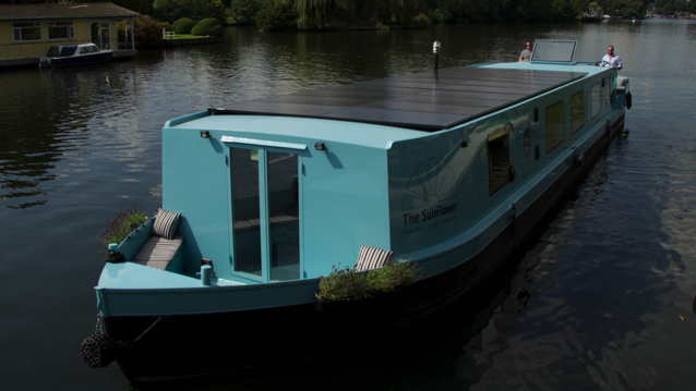 Canal boat in London, England with solar panels on the roof