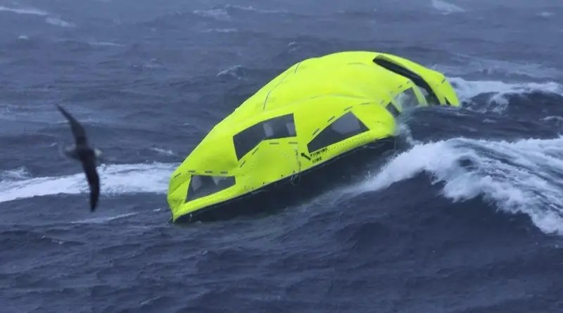 A yellow covered lifeboat is alone in rough waters