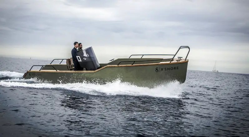 an 8 metre, 25 foot boat with two men going through the water